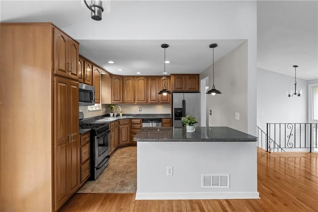 137 Loire Valley Dr, Shaler, PA 15209 - kitchen featuring decorative light fixtures, dark stone countertops, appliances with stainless steel finishes, and visible vents