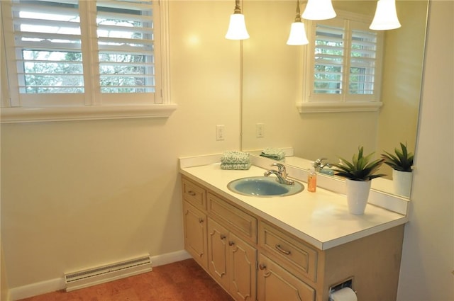 bathroom featuring baseboards, plenty of natural light, and vanity