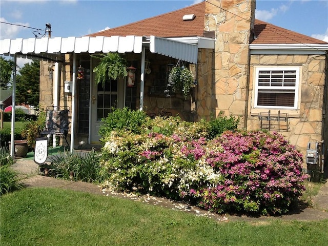 856 School St, Clairton, PA 15025 - view of side of property with a chimney, a shingled roof, and stone siding