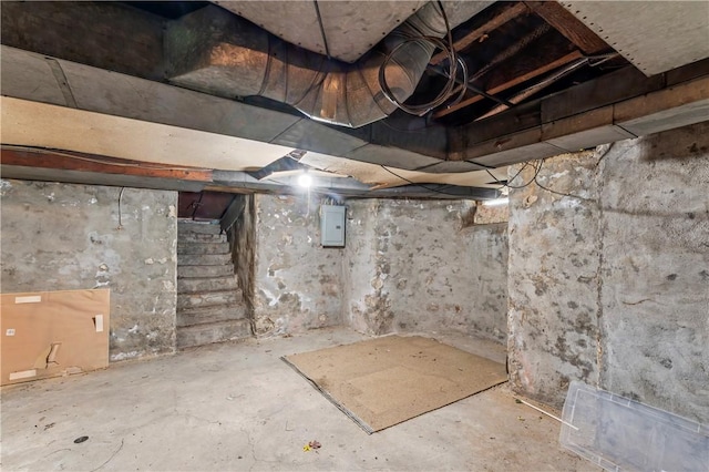 unfinished below grade area with stairway and electric panel