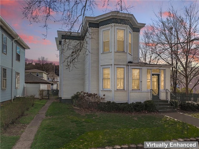 exterior space with a front lawn and fence