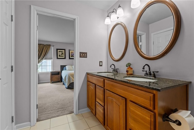 bathroom with tile patterned floors, double vanity, ensuite bathroom, and a sink