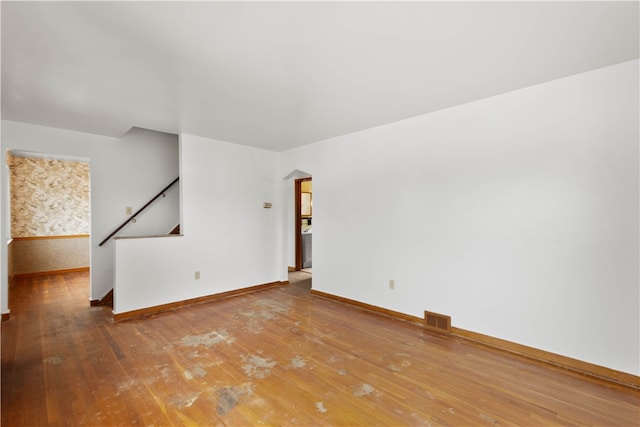 3555 Middleboro Rd, Castle Shannon, PA 15234 - unfurnished room with visible vents, baseboards, arched walkways, and hardwood / wood-style flooring