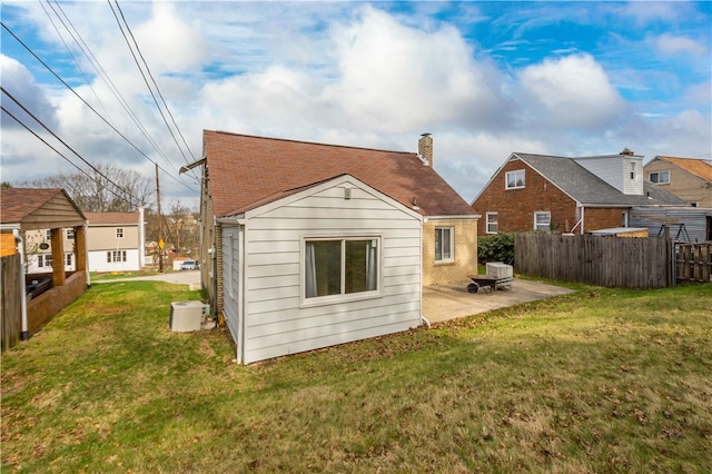 3555 Middleboro Rd, Castle Shannon, PA 15234 - back of property with a chimney, a patio area, brick siding, fence, and a lawn
