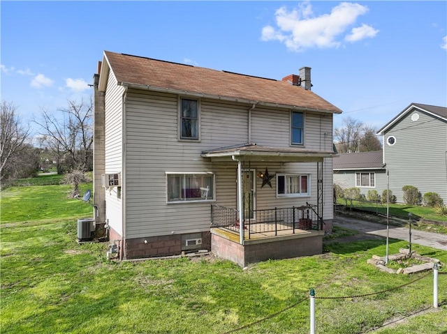 2814 W Crawford Ave, Connellsville, PA 15425 - rear view of property featuring central AC unit and a lawn
