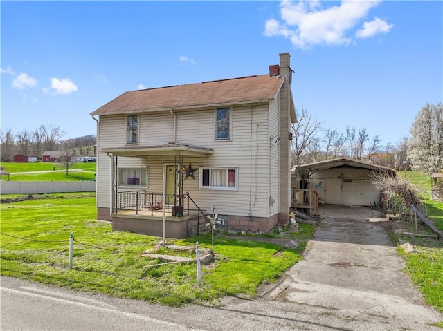 2814 W Crawford Ave, Connellsville, PA 15425 - view of front of property featuring aphalt driveway, a carport, fence, a front lawn, and a chimney