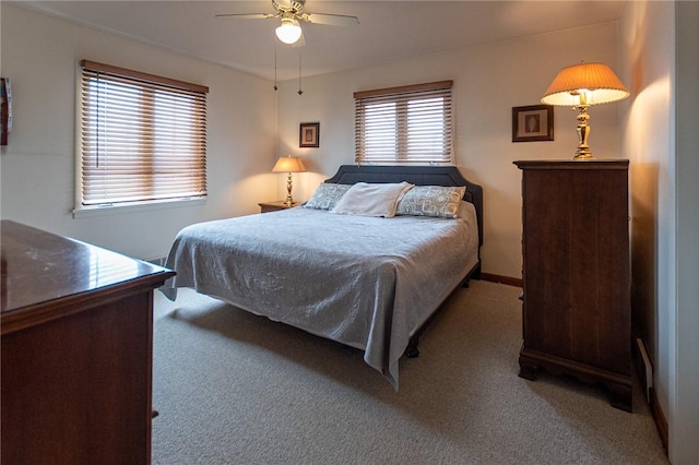 carpeted bedroom with baseboards and a ceiling fan