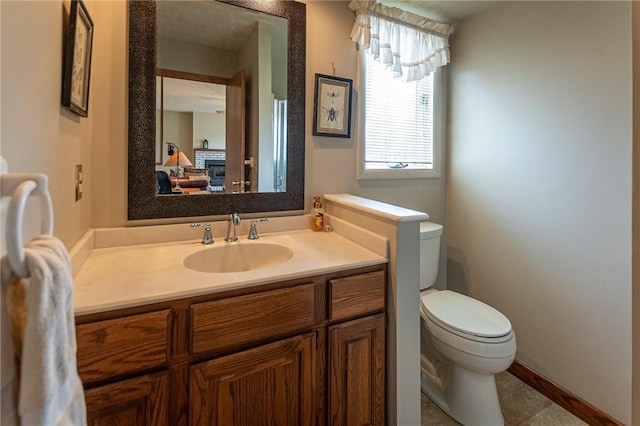 half bathroom featuring vanity, connected bathroom, and toilet