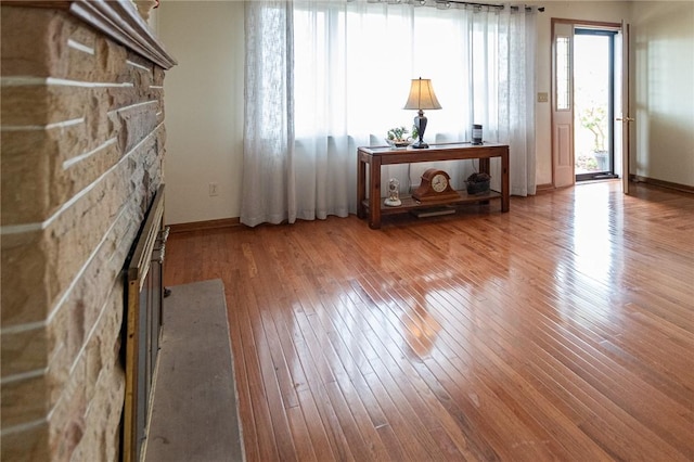 unfurnished living room featuring a fireplace and hardwood / wood-style flooring