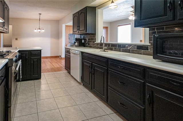 kitchen featuring light tile patterned flooring, dishwasher, light countertops, stainless steel range, and backsplash