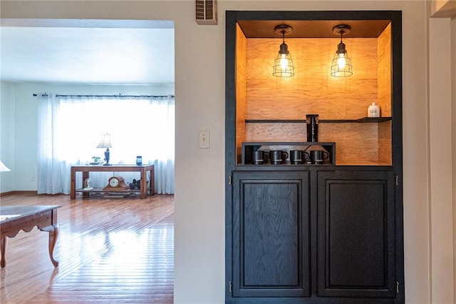 bar with visible vents and wood finished floors