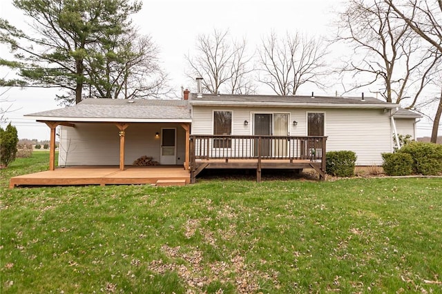 back of property featuring a yard and a wooden deck