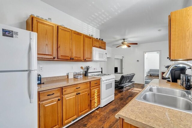 329 Downing St, Polish Hill, PA 15219 - kitchen featuring a sink, dark wood-style flooring, light countertops, ceiling fan, and white appliances