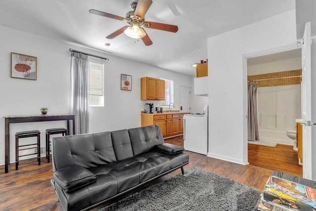 329 Downing St, Polish Hill, PA 15219 - living room featuring washer / clothes dryer, dark wood-style flooring, baseboards, and a ceiling fan