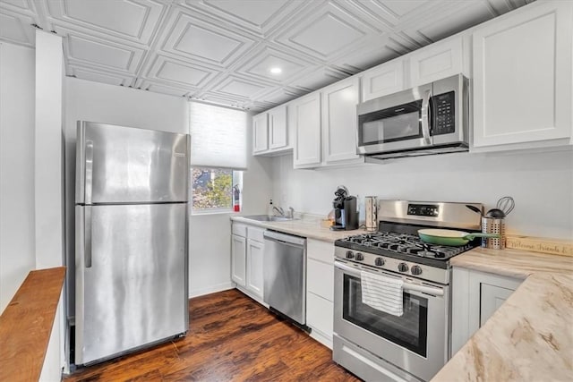 329 Downing St, Polish Hill, PA 15219 - kitchen with white cabinetry, an ornate ceiling, dark wood finished floors, stainless steel appliances, and a sink