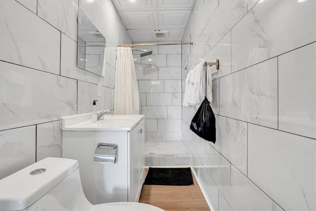 329 Downing St, Polish Hill, PA 15219 - bathroom with toilet, tile walls, vanity, wood finished floors, and tiled shower