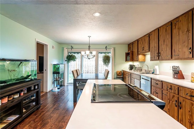 225 Circle Dr, White Oak, PA 15131 - kitchen with dishwasher, light countertops, a chandelier, dark wood-style floors, and brown cabinets