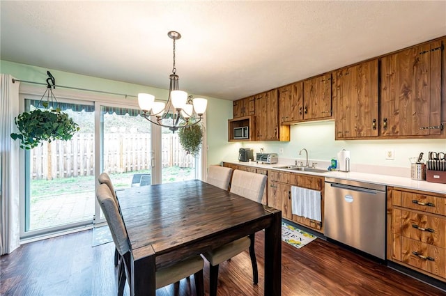 225 Circle Dr, White Oak, PA 15131 - kitchen with brown cabinets, an inviting chandelier, a sink, and stainless steel appliances