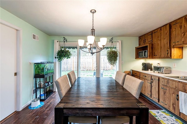225 Circle Dr, White Oak, PA 15131 - dining space featuring a chandelier, a toaster, visible vents, and dark wood finished floors