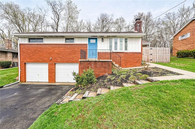 225 Circle Dr, White Oak, PA 15131 - single story home with an attached garage, aphalt driveway, a chimney, fence, and brick siding