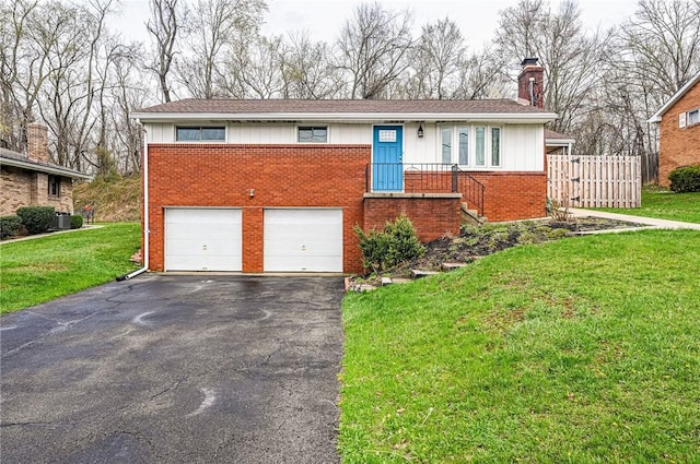 225 Circle Dr, White Oak, PA 15131 - ranch-style house featuring an attached garage, a chimney, brick siding, a front lawn, and driveway