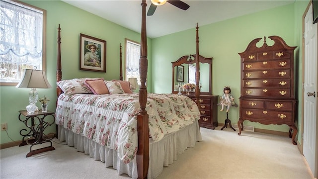 carpeted bedroom featuring multiple windows, a ceiling fan, and baseboards