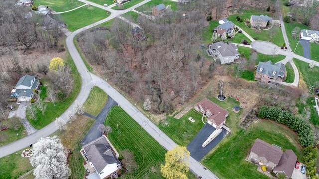 aerial view of property and surrounding area with nearby suburban area