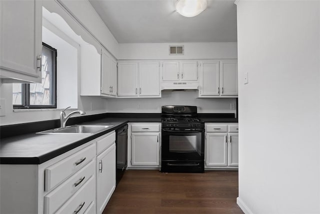 kitchen featuring under cabinet range hood, a sink, white cabinetry, and black appliances