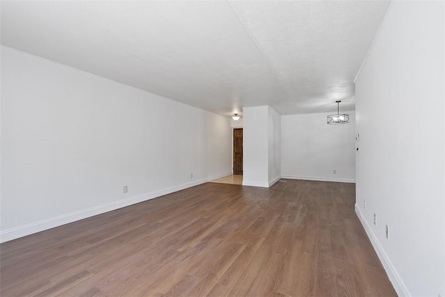 interior space with baseboards and wood finished floors