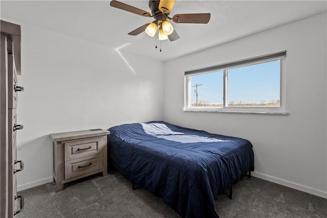 bedroom with ceiling fan, carpet flooring, and baseboards