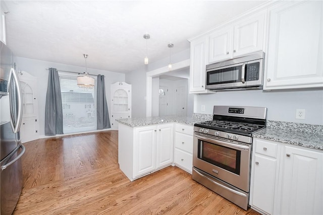 kitchen featuring a peninsula, appliances with stainless steel finishes, white cabinetry, and light wood-style floors