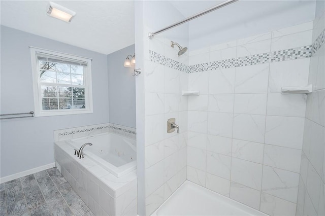 full bathroom featuring a tile shower, a jetted tub, wood finished floors, and baseboards