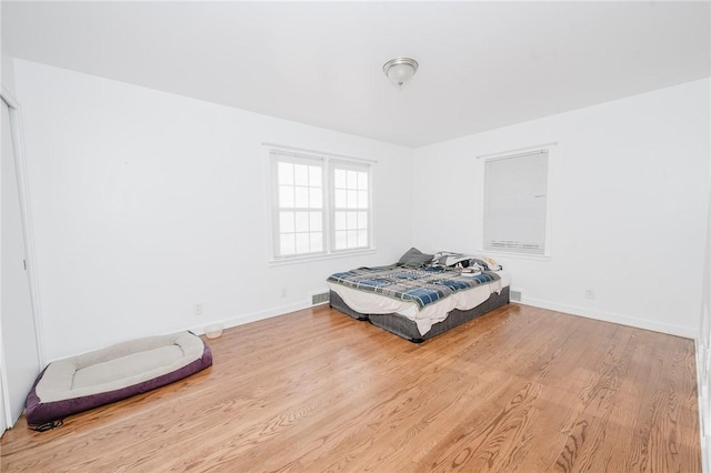 bedroom featuring wood finished floors and baseboards