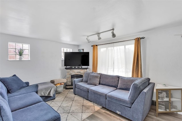 living room with rail lighting and light wood-type flooring