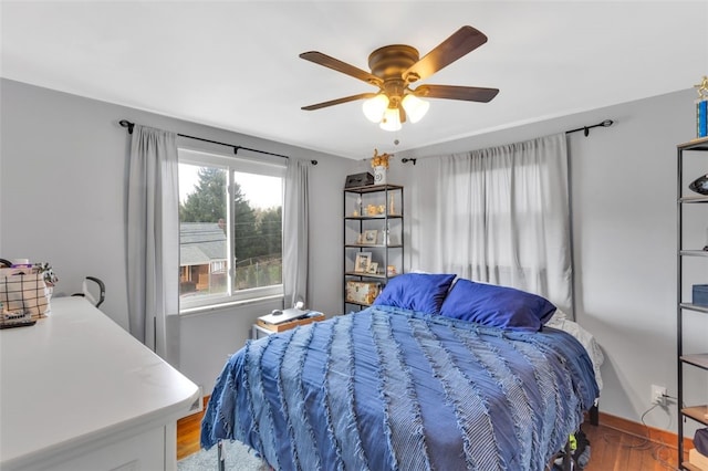 bedroom featuring wood finished floors and a ceiling fan
