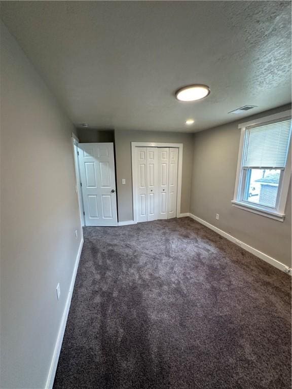 535 Grant Ave, Heidelberg, PA 15106 - unfurnished bedroom with a closet, dark colored carpet, visible vents, and baseboards