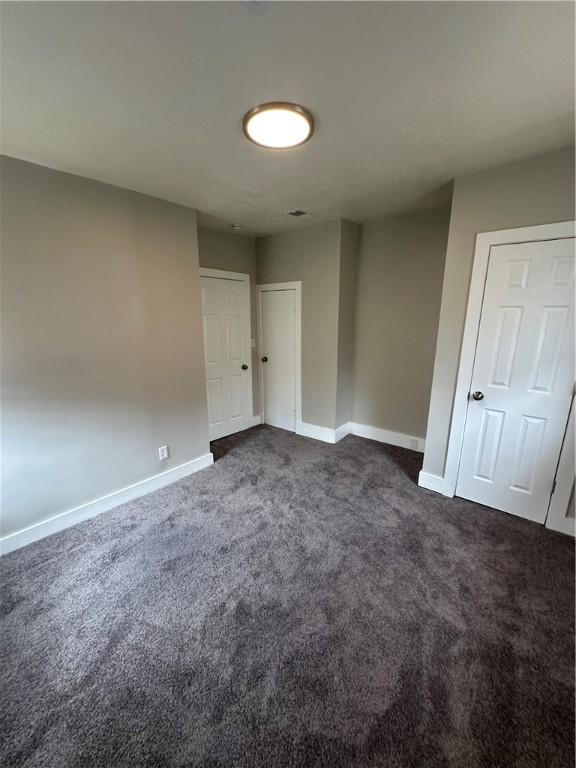 535 Grant Ave, Heidelberg, PA 15106 - unfurnished room with dark colored carpet and baseboards