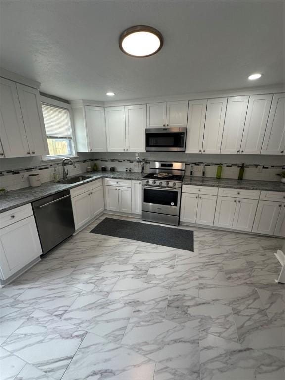 535 Grant Ave, Heidelberg, PA 15106 - kitchen featuring decorative backsplash, marble finish floor, a sink, and appliances with stainless steel finishes