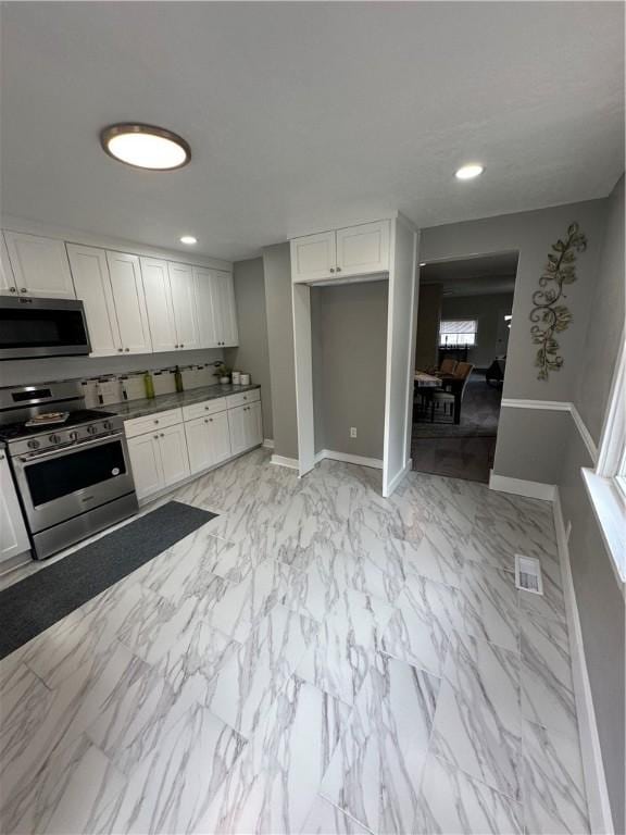 535 Grant Ave, Heidelberg, PA 15106 - kitchen with white cabinets, appliances with stainless steel finishes, and baseboards