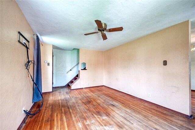210 Verna Dr, Shaler, PA 15209 - unfurnished living room with baseboards, a ceiling fan, a textured ceiling, stairs, and wood-type flooring
