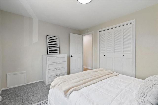 carpeted bedroom with a closet and baseboards