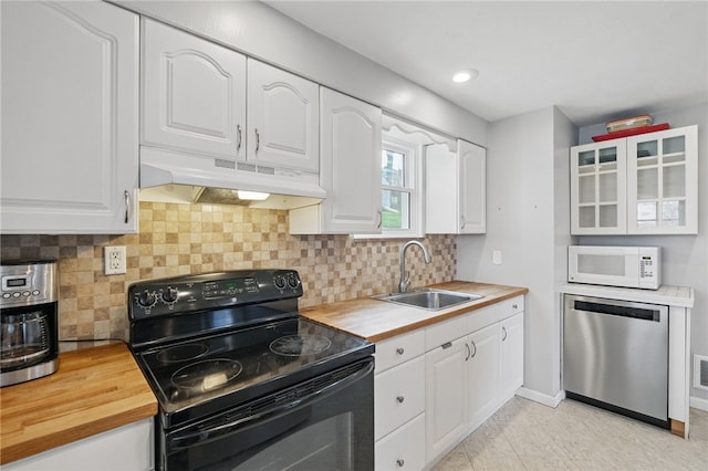 kitchen featuring black range with electric cooktop, dishwasher, a sink, under cabinet range hood, and white microwave