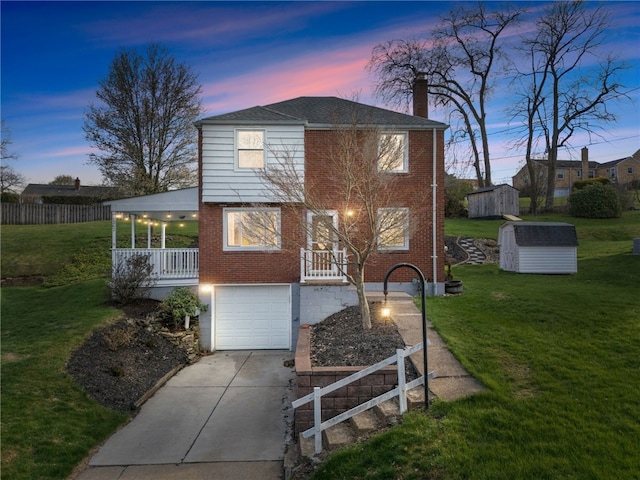 view of front of house with an attached garage, a storage shed, driveway, and a lawn