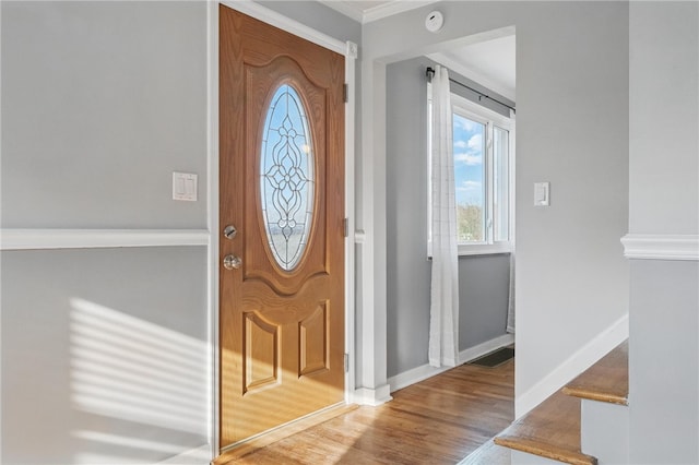 entryway featuring baseboards and wood finished floors