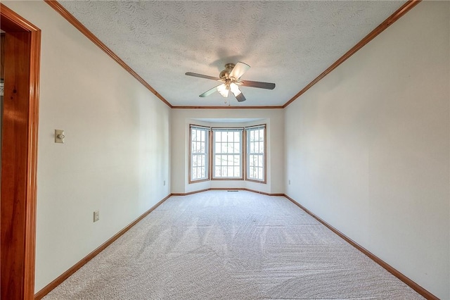 unfurnished room featuring light carpet, baseboards, a ceiling fan, and a textured ceiling