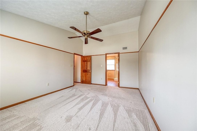 unfurnished room with baseboards, light carpet, a textured ceiling, a ceiling fan, and visible vents