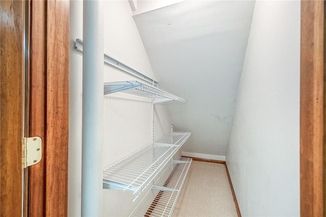 interior space featuring lofted ceiling and carpet