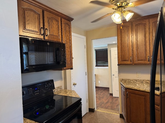 21 Garden Ter, Churchill Boro, PA 15221 - kitchen with black appliances, ceiling fan, light stone counters, and brown cabinetry