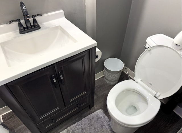 21 Garden Ter, Churchill Boro, PA 15221 - bathroom with toilet, vanity, wood finished floors, and baseboards