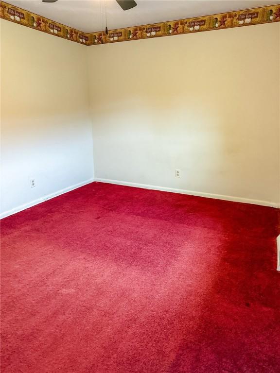 210 Locust St, Rural Valley Boro, PA 16249 - unfurnished room featuring baseboards, dark carpet, and ceiling fan